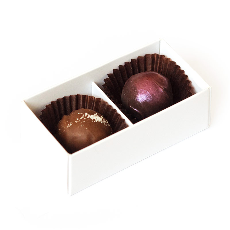 Two handmade truffles packed in a small box