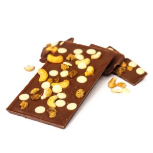 Milk chocolate block topped with white mulberries, cashew nuts and white chocolate buttons