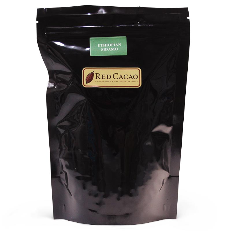 A black bag of 500 gram freshly roasted coffee beans