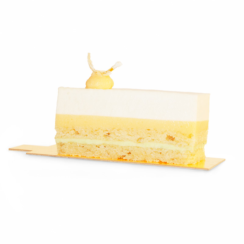 Slice of layered mousse, lemon curd, mint cream and almond sponge cake